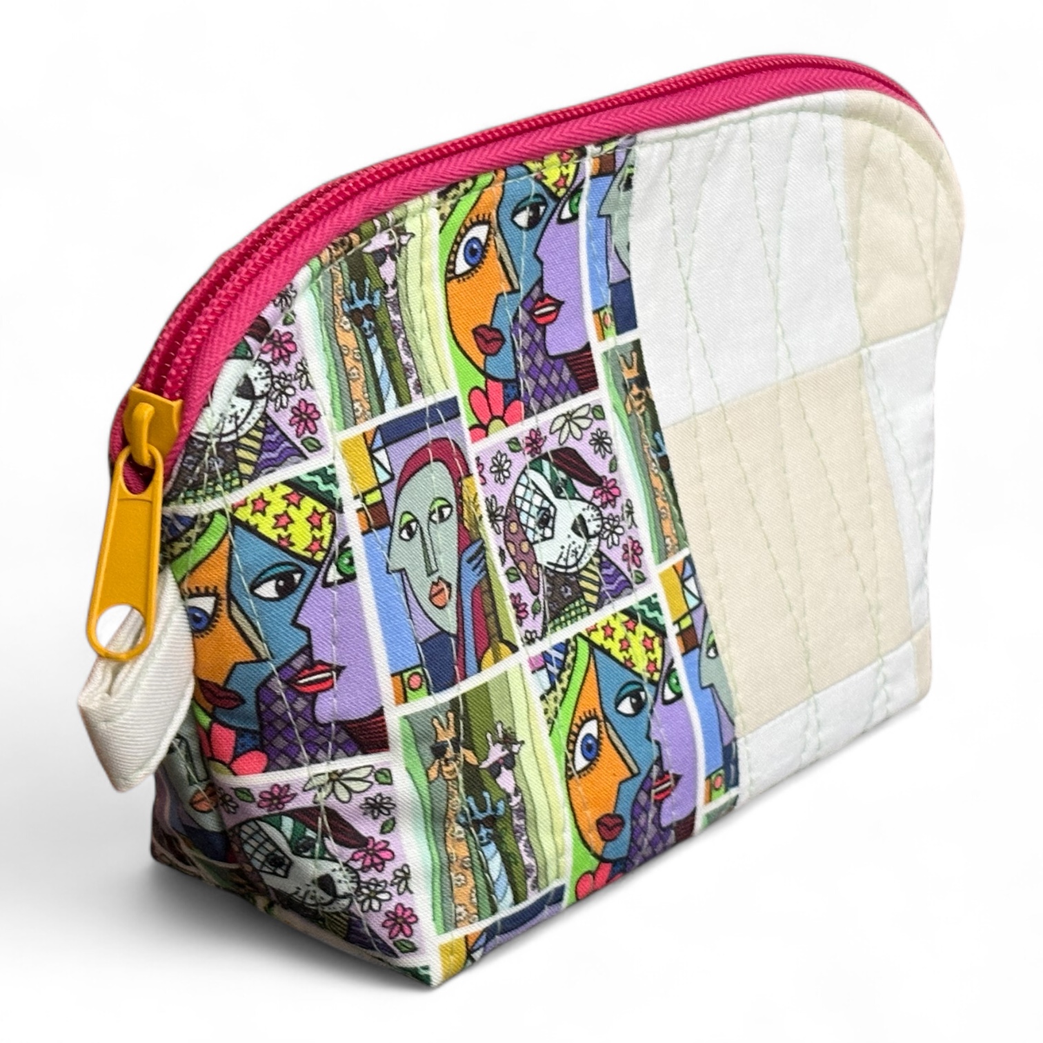 Colorful zippered makeup bag featuring a patchwork design with abstract faces and patterns.