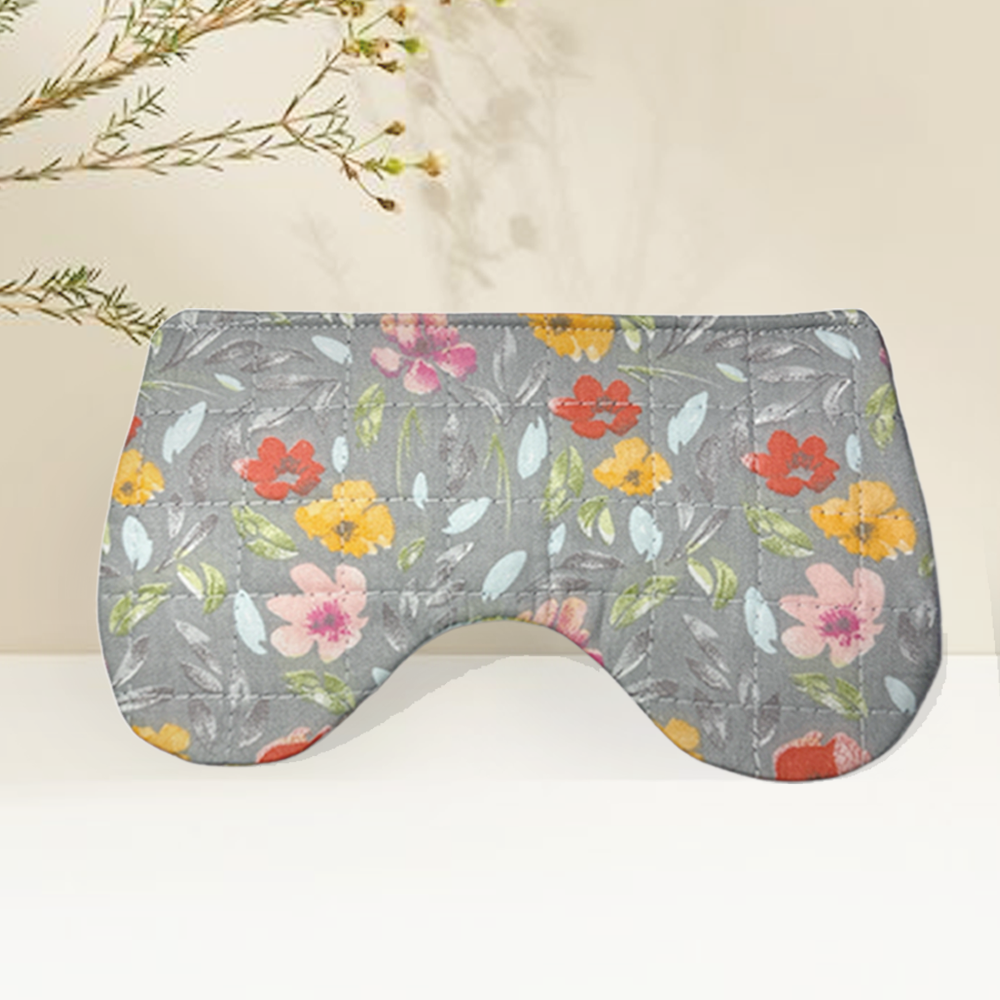 Floral-patterned grey eye mask with colorful flowers and leaves, designed for relaxation and sleep.